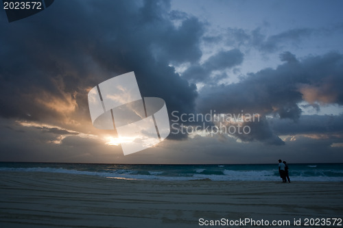 Image of Couple on shore at sanset 