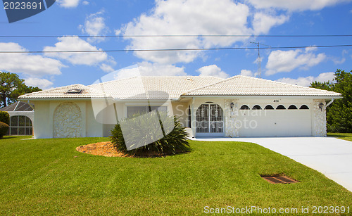 Image of Luxury family house with landscaping on the front and blue sky o