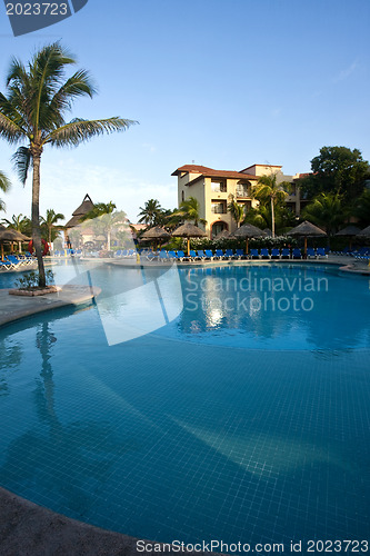 Image of Beautiful pool and patio in tropical setting 