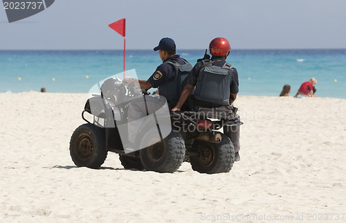 Image of Coast police cheking the beach.