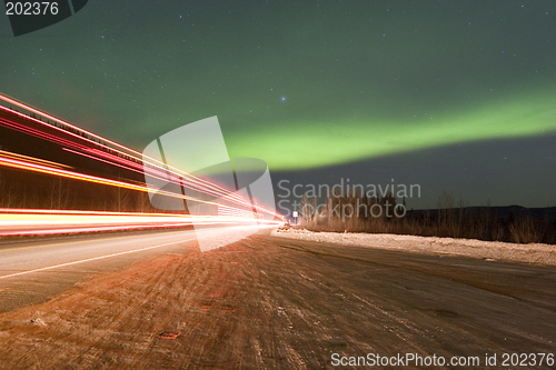 Image of Truck lights and aurora borealis