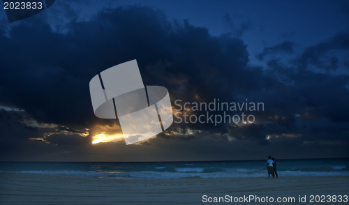 Image of Couple on shore at sanset 