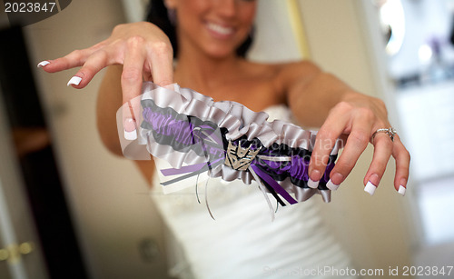 Image of Bride dressing for the wedding ceremony 