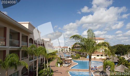 Image of Beautiful pool and patio in tropical setting 