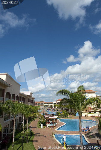 Image of Beautiful pool and patio in tropical setting 