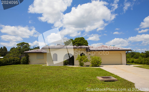 Image of Luxury family house with landscaping on the front and blue sky o