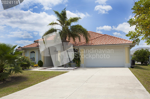 Image of Luxury family house with landscaping on the front and blue sky o