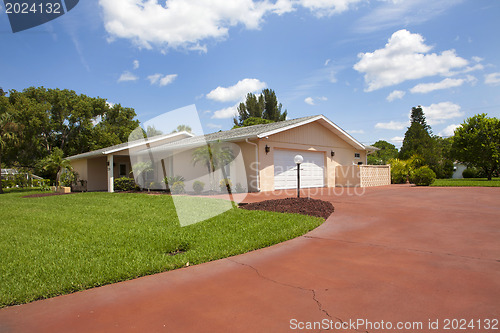 Image of Luxury family house with landscaping on the front and blue sky o