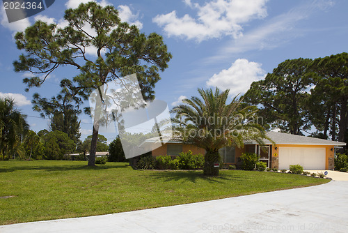 Image of Luxury family house with landscaping on the front and blue sky o