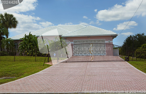 Image of Luxury family house with landscaping on the front and blue sky o