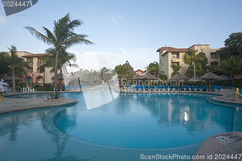 Image of Beautiful pool and patio in tropical setting 