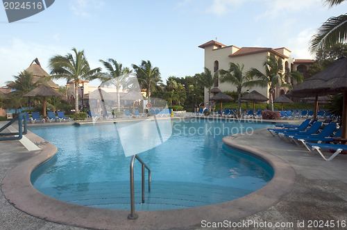 Image of Beautiful pool and patio in tropical setting 