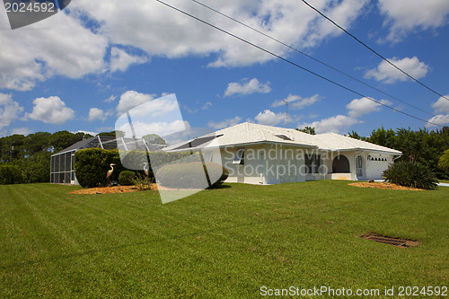 Image of Luxury family house with landscaping on the front and blue sky o