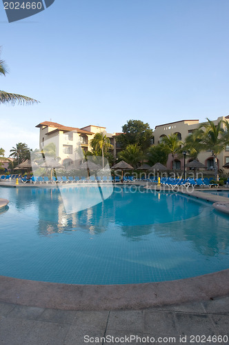 Image of Beautiful pool and patio in tropical setting 