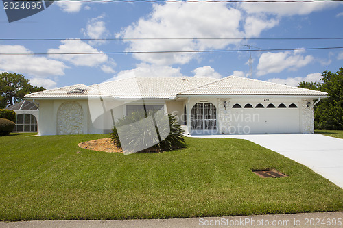 Image of Luxury family house with landscaping on the front and blue sky o