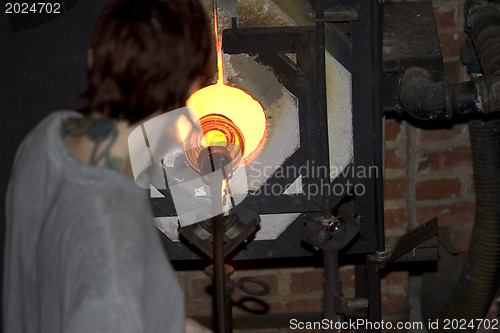 Image of Glass furnace. Glass Blower at Work