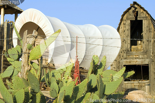 Image of Western covered wagon on yard of Fort