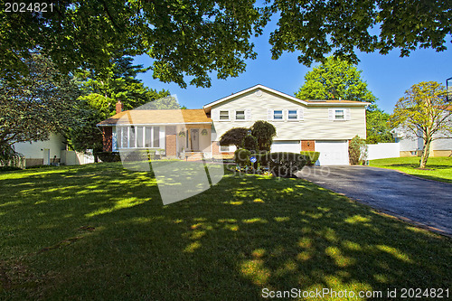 Image of Luxury family house with landscaping on the front and blue sky o