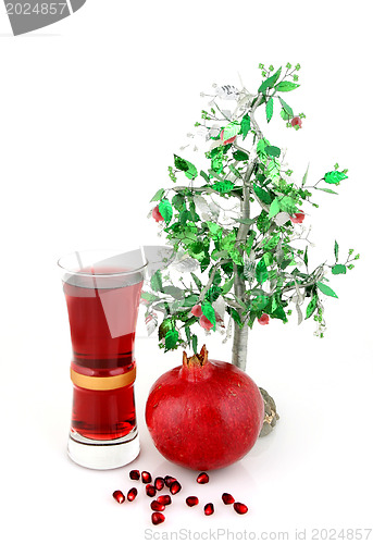 Image of pomergranate and glass of juice isolated on white