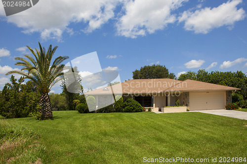 Image of Luxury family house with landscaping on the front and blue sky o