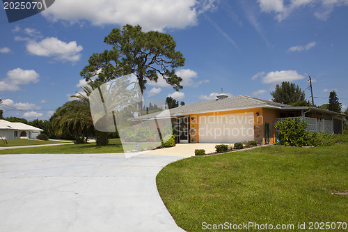 Image of Luxury family house with landscaping on the front and blue sky o