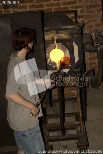 Image of Glass furnace. Glass Blower at Work