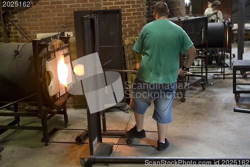 Image of Glass furnace. Glass Blower at Work