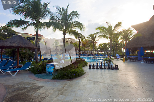 Image of Beautiful pool and patio in tropical setting 
