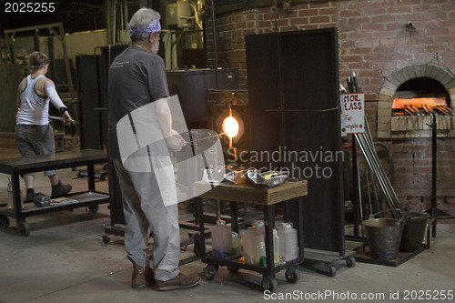 Image of Glass furnace. Glass Blower at Work