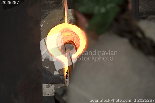 Image of Glass furnace. Glass Blower at Work