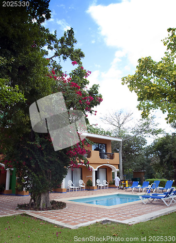 Image of Beautiful pool and patio in tropical setting 