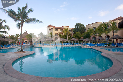 Image of Beautiful pool and patio in tropical setting 