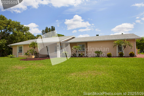 Image of Luxury family house with landscaping on the front and blue sky o