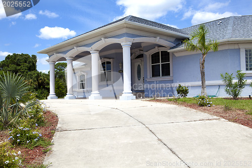 Image of Luxury family house with landscaping on the front and blue sky o