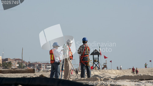 Image of Constructions working on the beach 