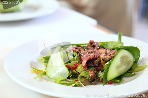 Image of Salad with a meat on the plate