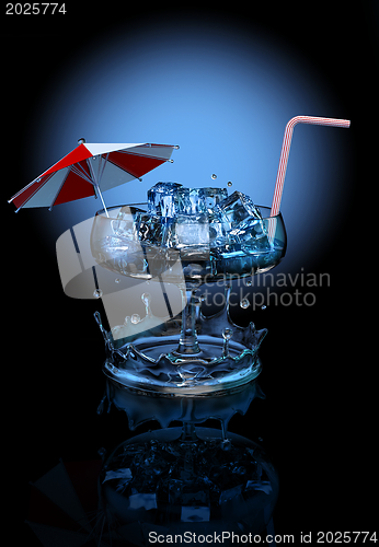 Image of cocktail with ice cubes, umbrella and straw