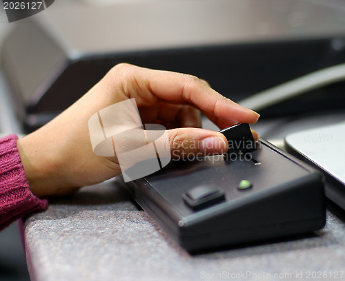 Image of Woman's hand holding a slider control in a laboratory environment