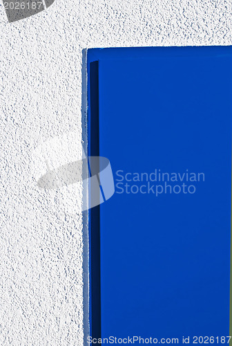 Image of blue door and white wall