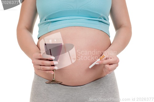 Image of Pregnant belly with wine and cigarettes