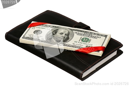 Image of Dollars and notepad