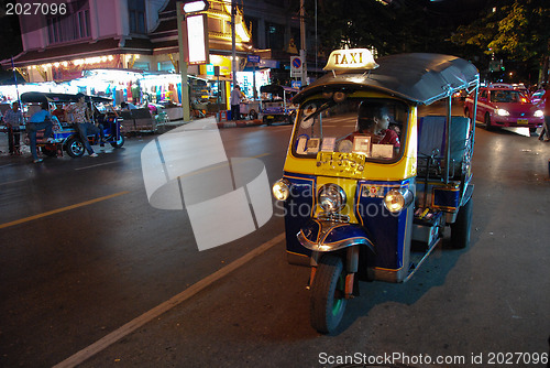 Image of BANGKOK - AUG 10: A three wheeled tuk tuk taxi on a street in th