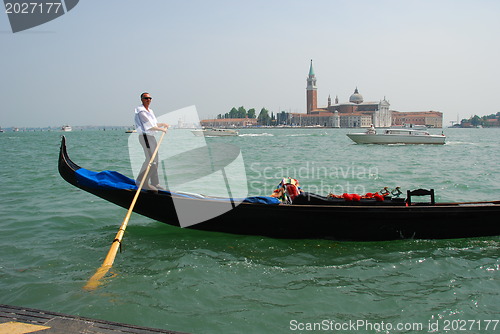Image of VENICE - MAY 27: Gondoliere on his Gondola in famous lagoon wate
