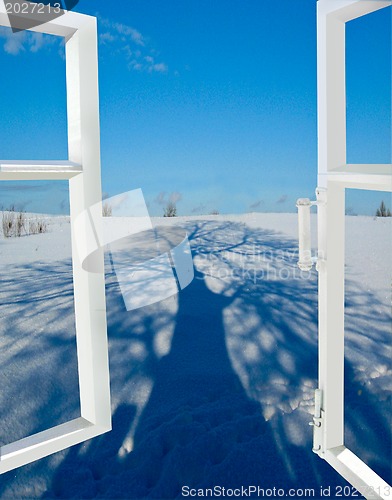 Image of open window to a snow with the shadow of tree