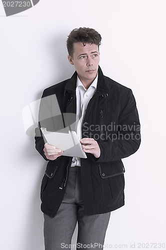 Image of Pensive man holding a tablet
