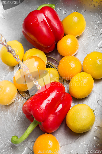 Image of Washing red and yellow fruits and vegetables