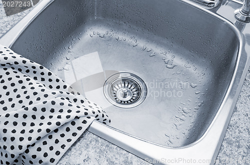 Image of Clean sink and kitchen towel