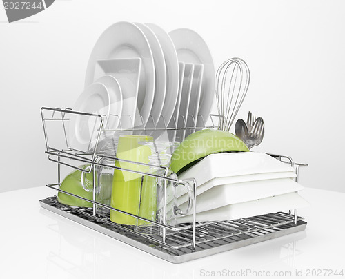 Image of Bright dishes drying on metal dish rack