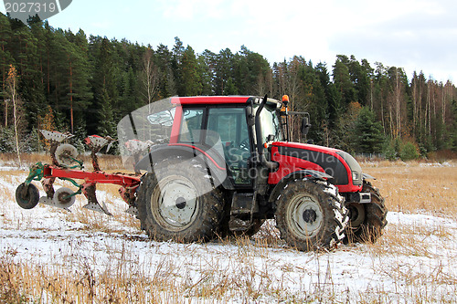 Image of Red Tractor on Field in Early Winter