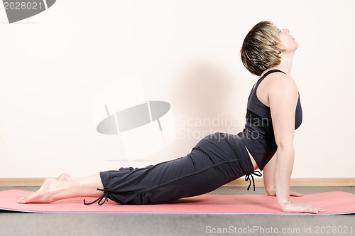 Image of young woman doing yoga exercises